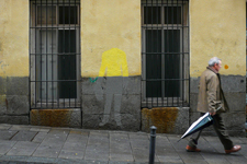 Homme qui marche dans la rue avec un parapluie
